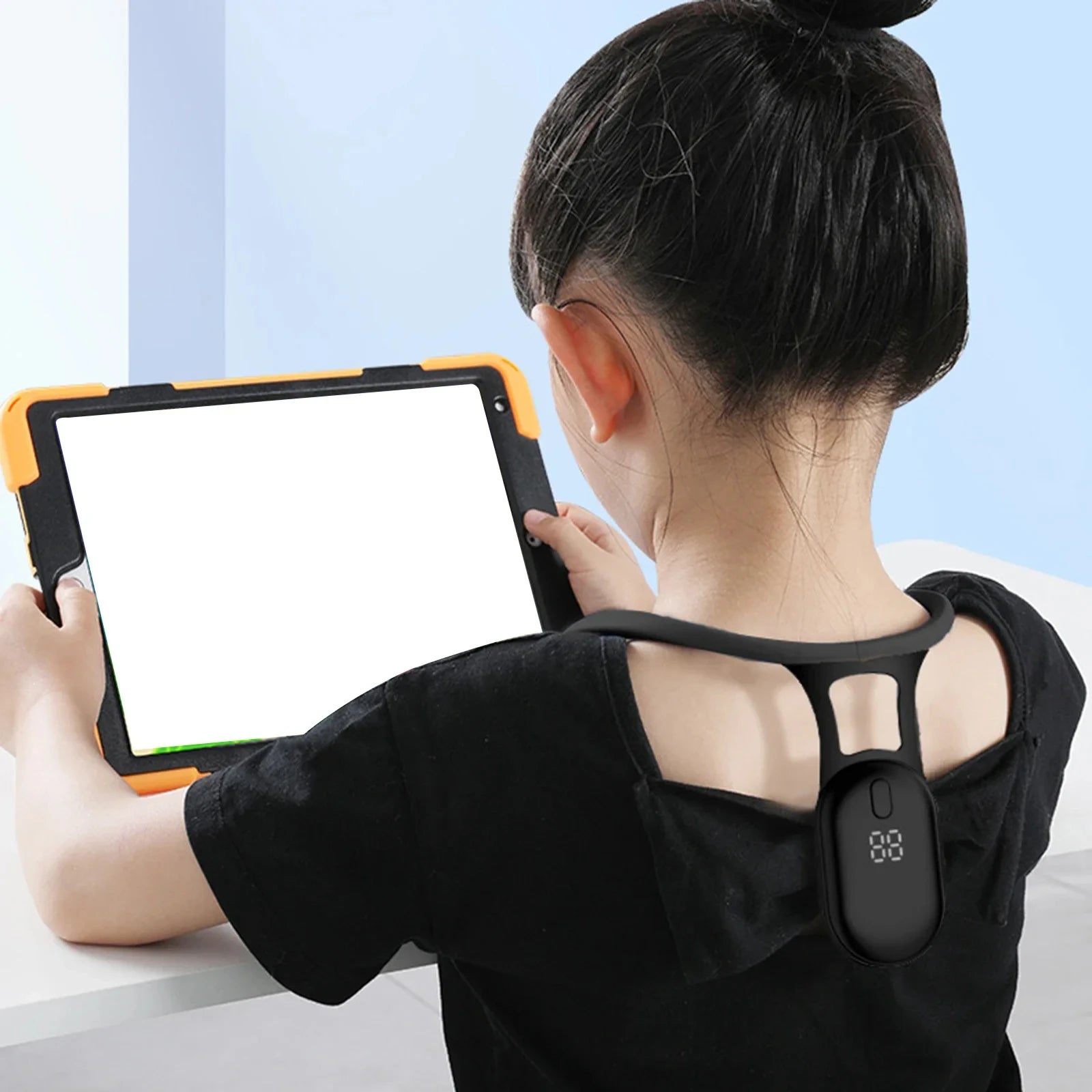 Child seated with tablet wearing posture corrector—promoting healthy sitting habits and ergonomic support during screen time
