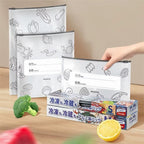 Reusable eco-friendly food storage bags with aluminum foil wraps on kitchen counter, labeled in Japanese for freezing and refrigeration, surrounded by fresh produce.