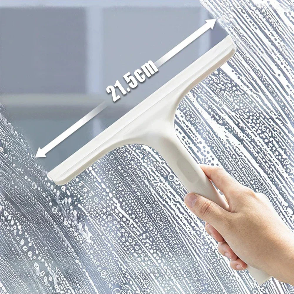 Hand using white squeegee to wipe soapy glass—21.5 cm blade shown removing water and streaks for a clear, spotless finish